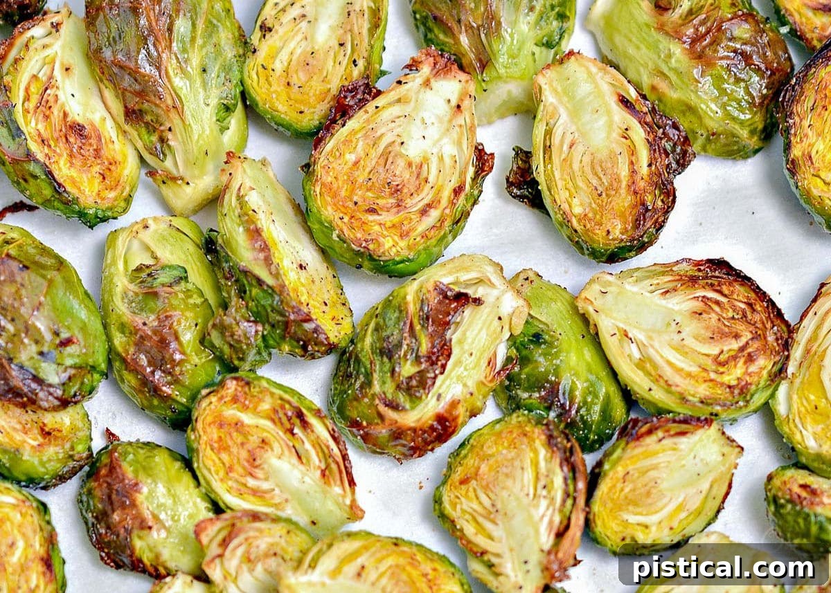 Addictive Air Fryer Brussels with Garlic and Parmesan 5 Golden and crispy brussels sprouts arranged in a single layer in an air fryer basket