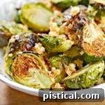 air fryer brussel sprouts in white bowl seasoned with garlic and Parmesan