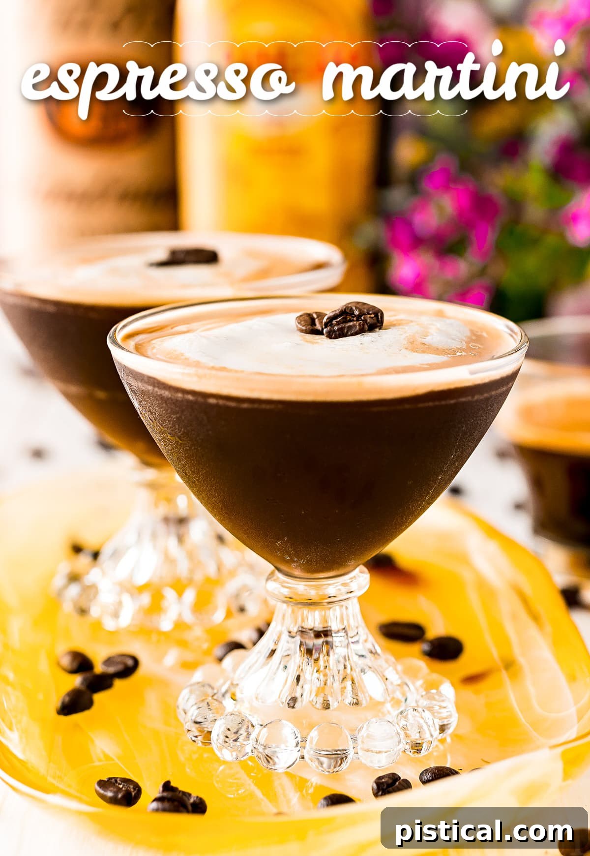 Two Espresso Martinis in elegant martini glasses on a yellow tray, with liquor bottles subtly blurred in the background, creating an inviting, sophisticated atmosphere.