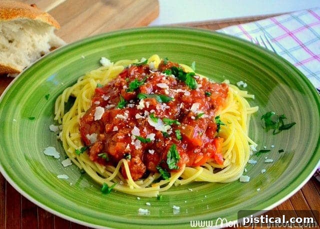 A bowl of delicious Slow Cooker Spaghetti topped with fresh herbs and cheese