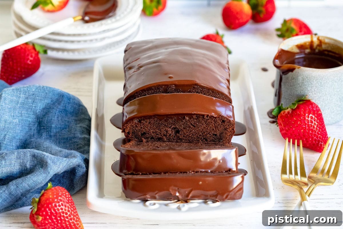 Decadent Chocolate Loaf 3 A beautifully presented chocolate pound cake loaf with three meticulously cut slices, arranged on a elegant white tray. Golden forks are placed neatly beside it, with a scattering of ripe, red strawberries adding a pop of color and freshness.