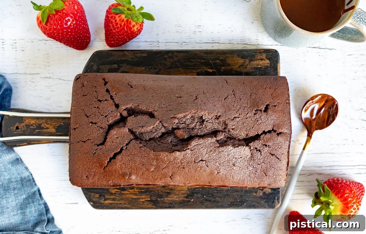 Decadent Chocolate Loaf 9 A perfectly baked chocolate pound cake cooling gently on a wooden board, awaiting its delicious glaze and eager anticipation of being served.