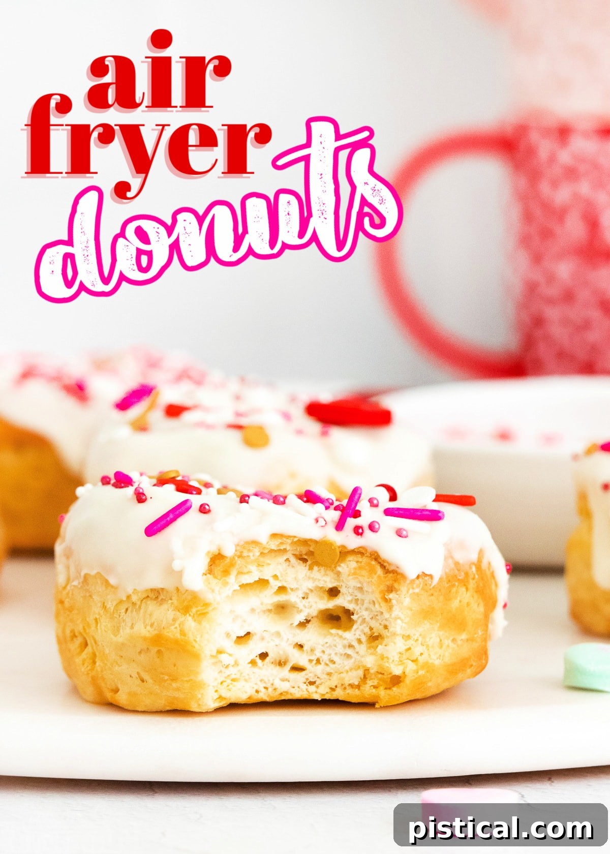 Easy Air Fryer Biscuit Donuts 2 Air fryer donut with vanilla glaze and Valentine's Day sprinkles, with a bite taken out, featuring a subtle title overlay.