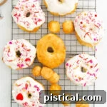 Glazed and decorated donuts cooling on a wire rack, ready to serve.