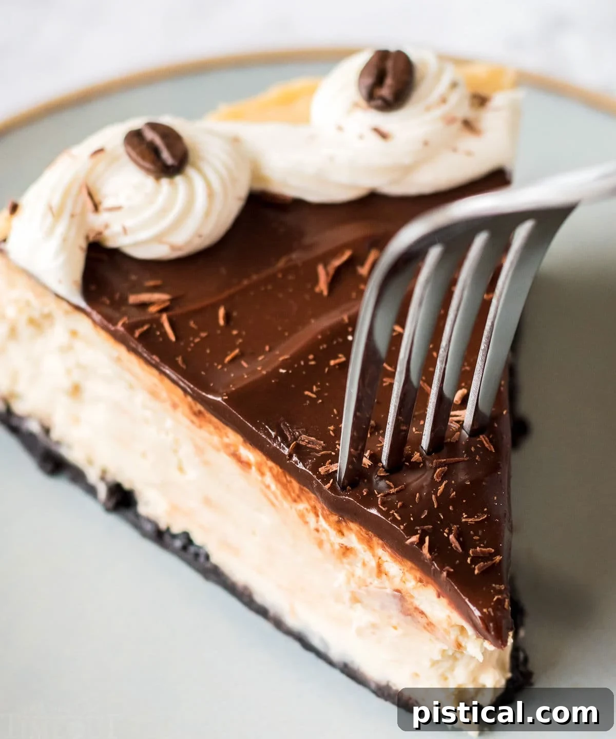 A close-up of a slice of espresso cheesecake with a fork gracefully descending into it, ready for a taste.