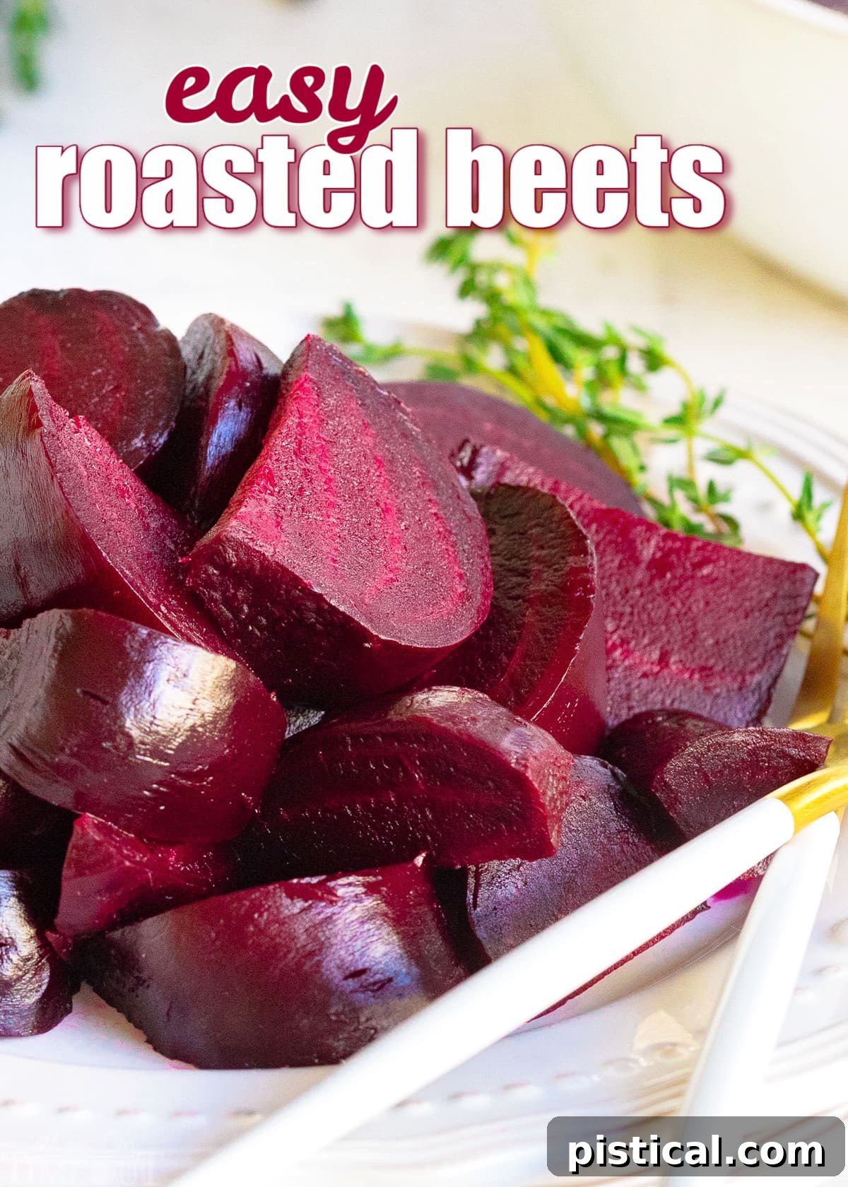 How to Make Perfect Roasted Beets 2 Roasted beets cut into wedges on a white plate with a sprig of fresh thyme for garnish, ready to be served.