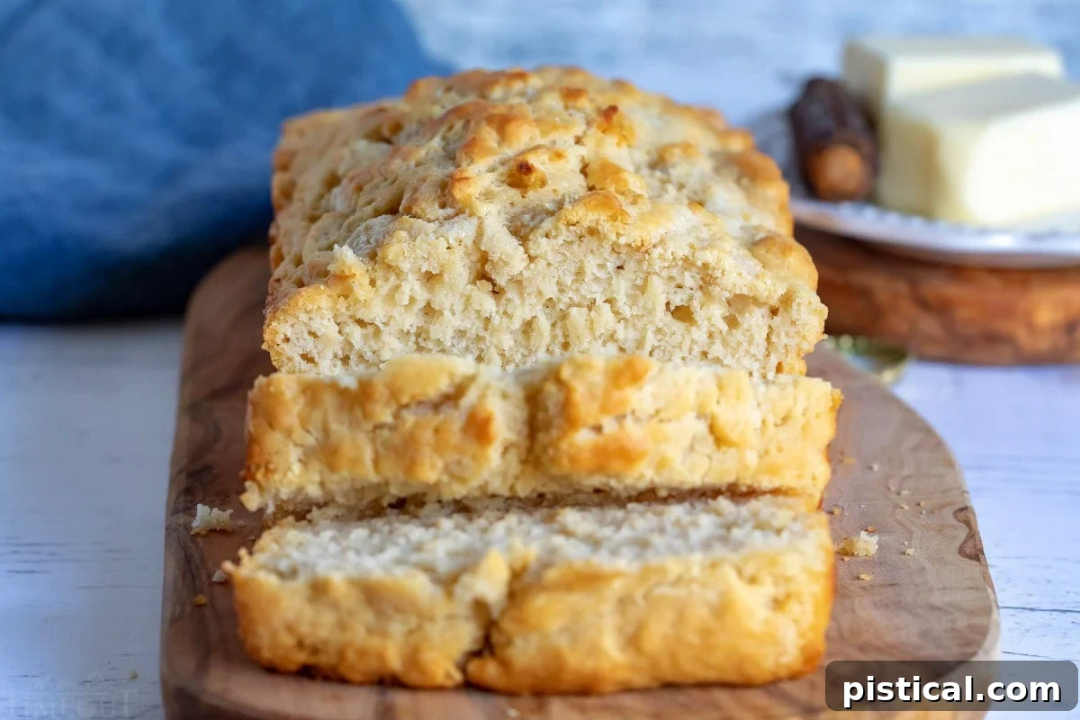 Two slices of golden brown beer bread, cut in half, showcasing the airy texture and inviting crust.