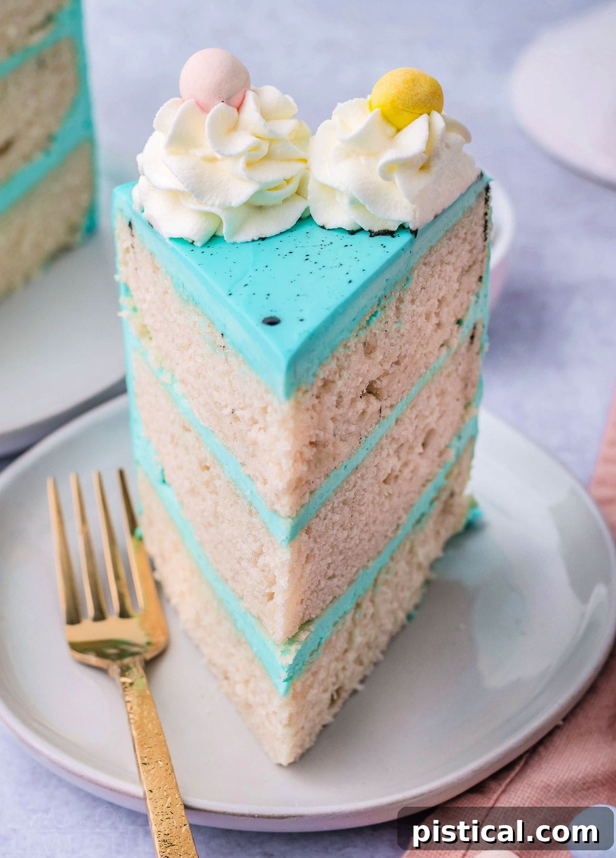 one slice of vanilla cake decorated with blue frosting and cadbury eggs.