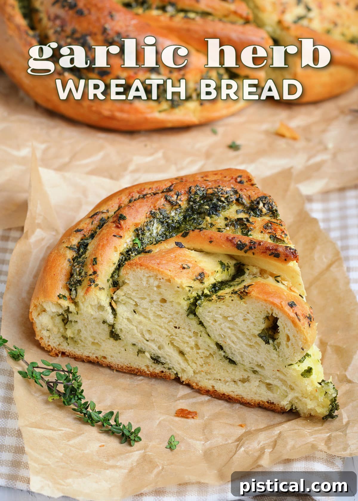 A beautifully golden-brown garlic herb bread wreath, with a slice already cut, showcasing the herby swirl inside.