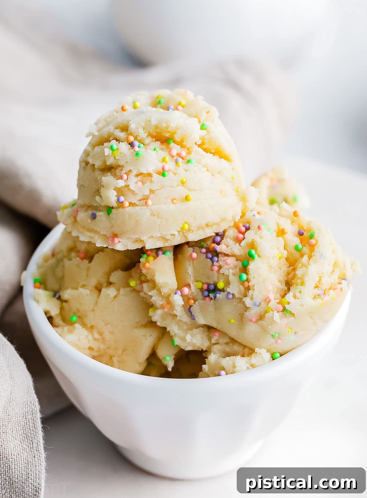 Ready-to-Eat Sugar Cookie Dough 6 Edible cookie dough with vibrant sprinkles, served in a clean white bowl, ready to be enjoyed.