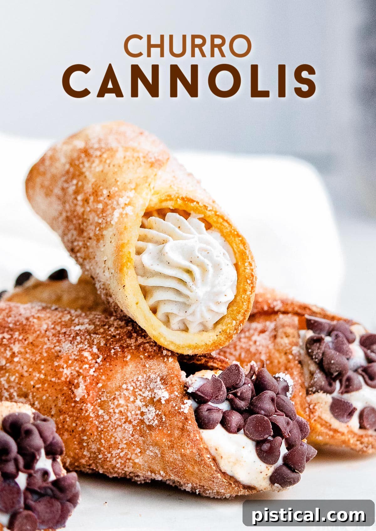 Three cannolis sitting on a white plate with cannoli filling and chocolate chips.