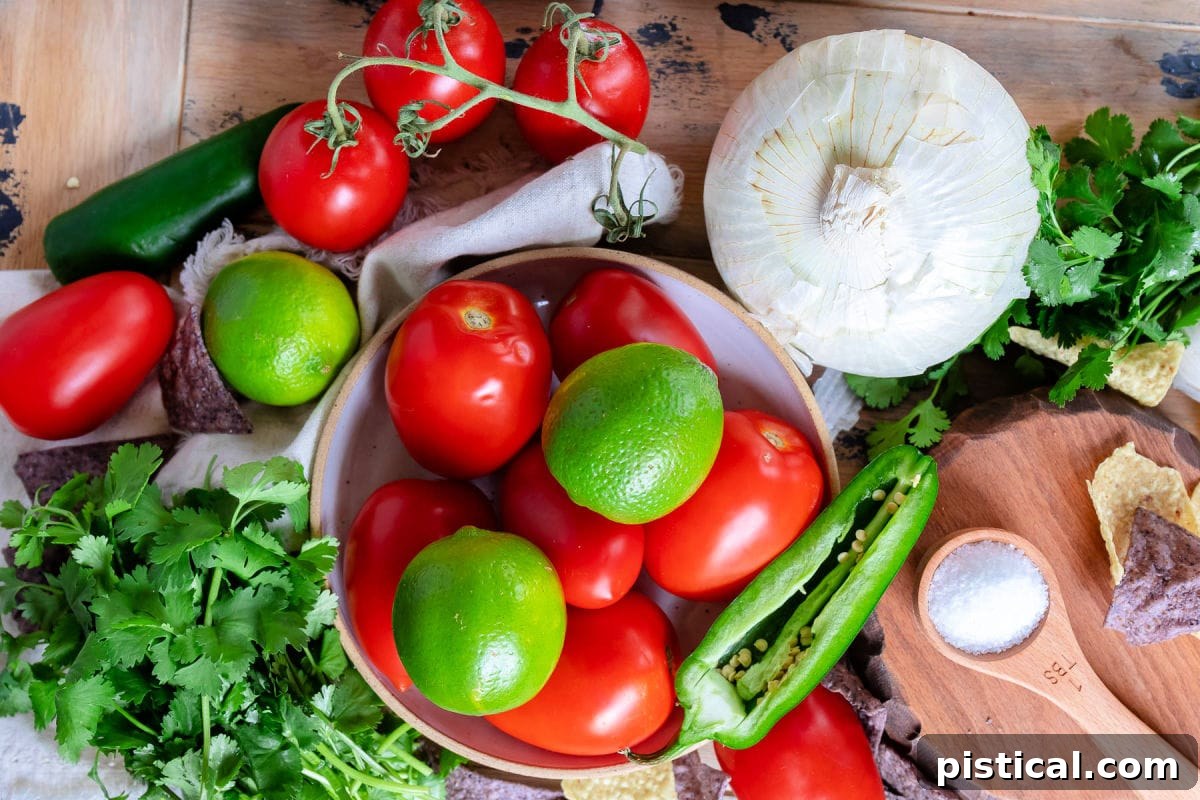 Top-down view of all the fresh Pico de Gallo ingredients, including Roma tomatoes, white onion, cilantro, jalapeño, and lime, neatly arranged on a rustic wooden board, ready for preparation.
