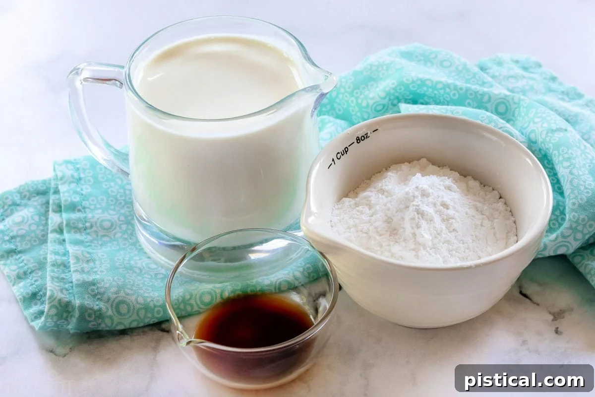 Whipped cream ingredients: cold heavy cream, powdered sugar, and vanilla extract, measured out and ready to use.
