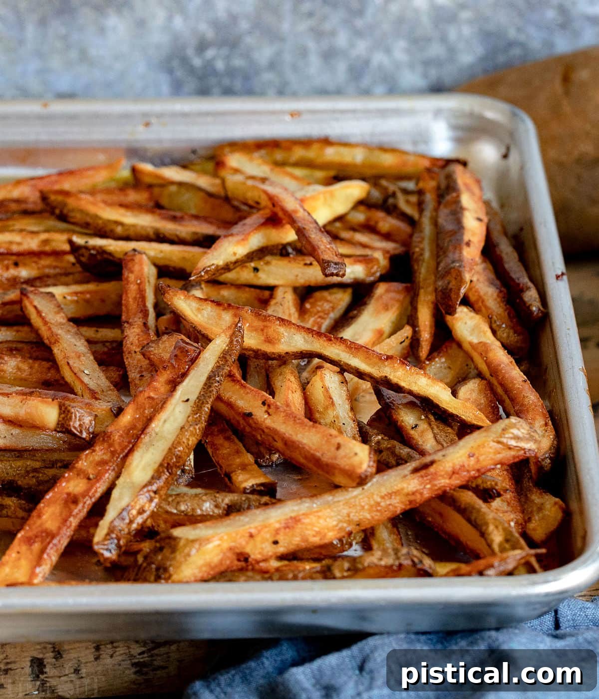 lots of crispy oven fries on baking sheet.