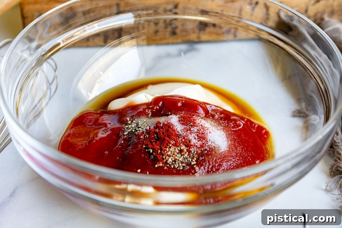 All the Fry Sauce recipe ingredients beautifully combined and ready to be whisked in a large glass bowl.
