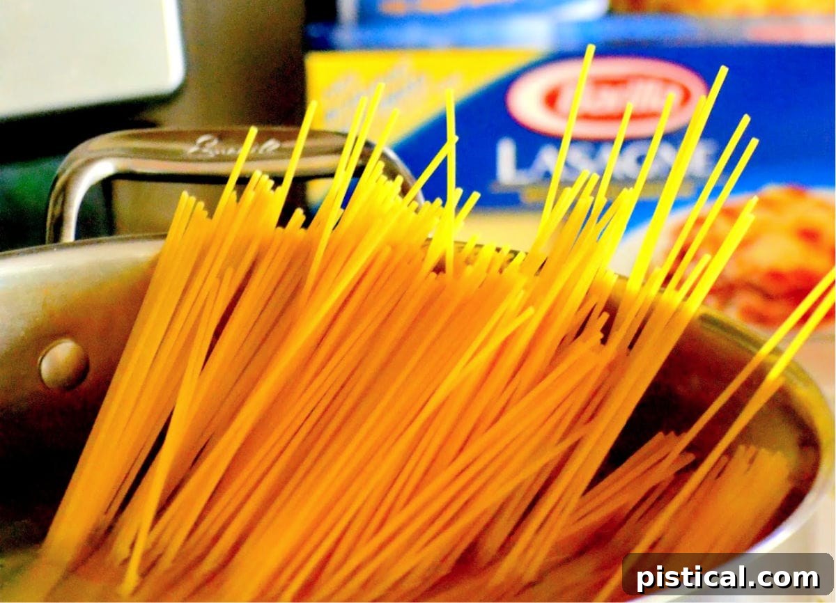 Zesty Lemon Pasta 5 spaghetti noodles in large pot with water not yet cooked