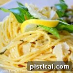 Zesty Lemon Pasta 8 plate of lemon spaghetti garnished with parmesan lemon and basil square