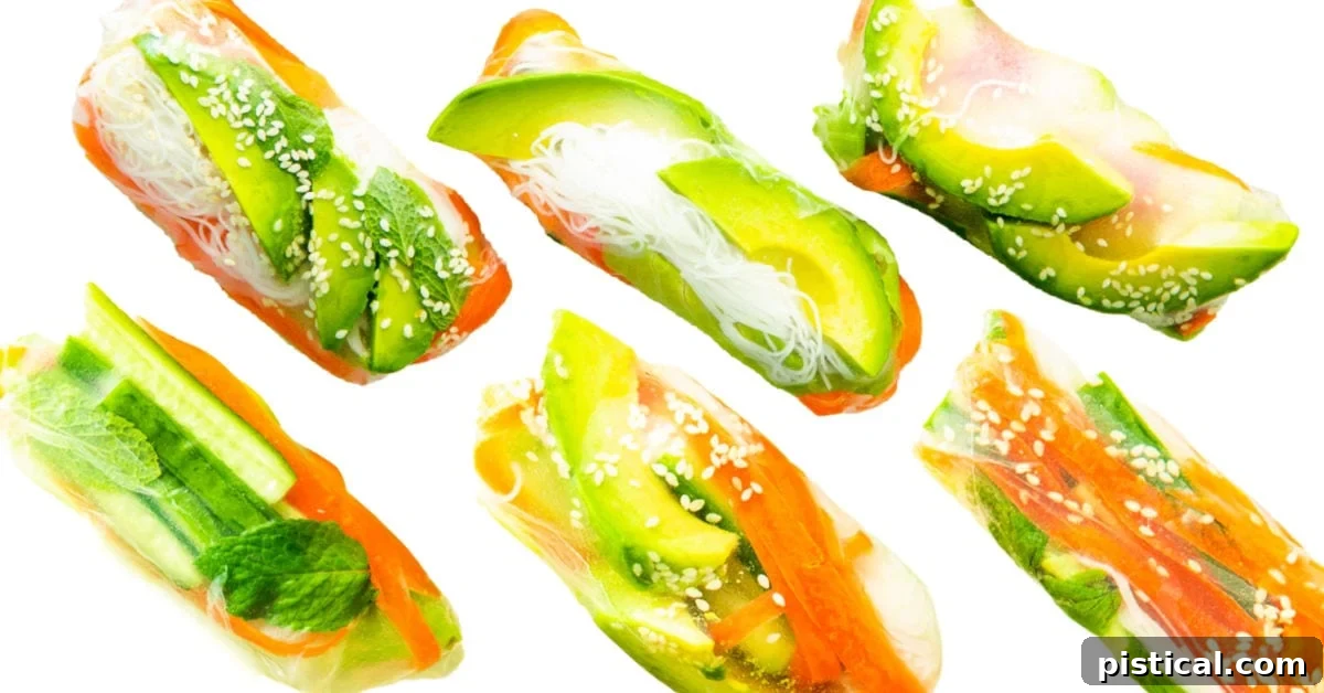 6 spring rolls on white background all rolled and ready to enjoy. Made with avocado and carrots.