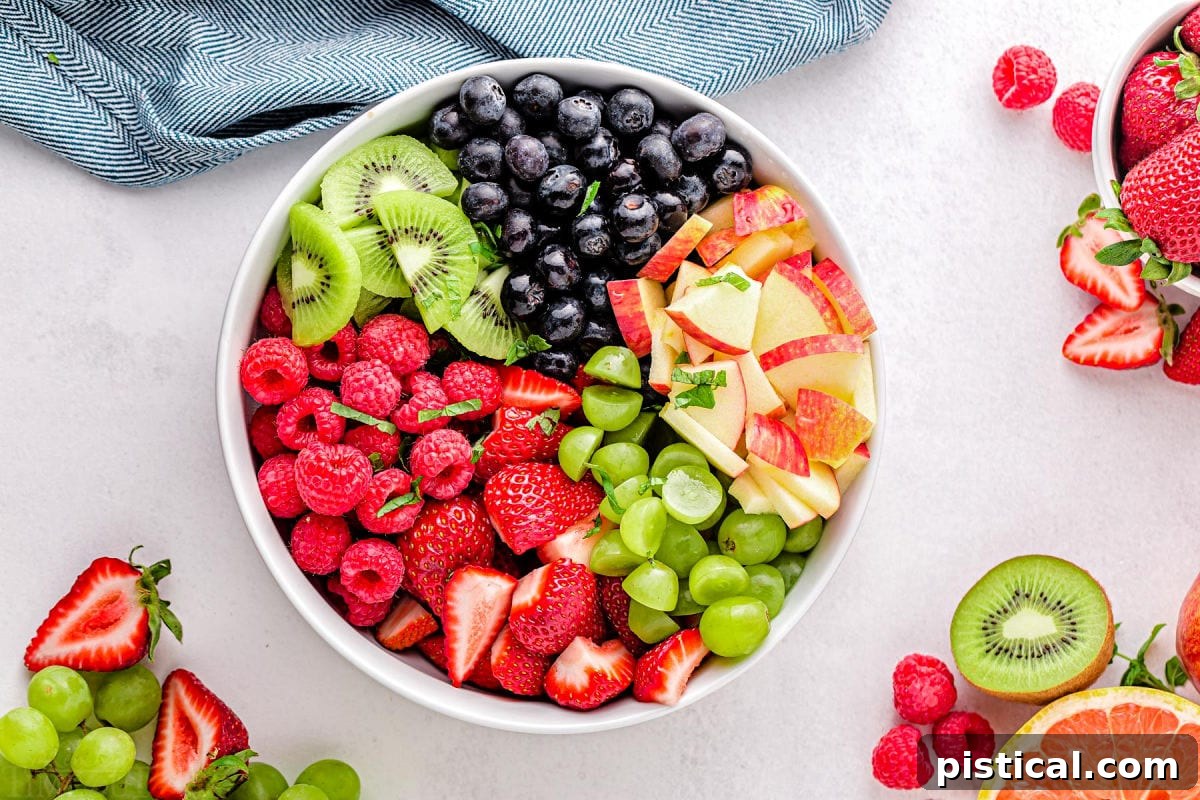 Nature's Candy Bowl 4 Fresh fruit salad ingredients beautifully arranged in a bowl, waiting to be tossed together with the dressing.