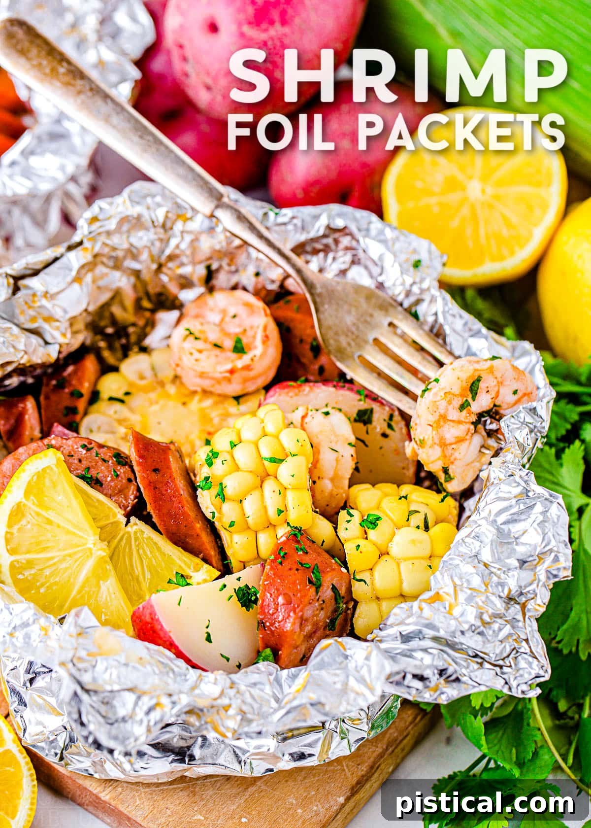 Shrimp boil cooked in foil with corn, sausage, shrimp and potatoes. Overhead view of a single packet opened, revealing succulent contents.