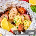 Grilled shrimp boil made in foil packets with corn, sausage and shrimp.