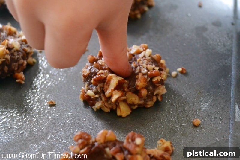 Caramel Pecan Turtle Thumbprints 3 An array of beautifully crafted Turtle Thumbprint Cookies, showcasing their delicate appearance and tempting caramel centers.