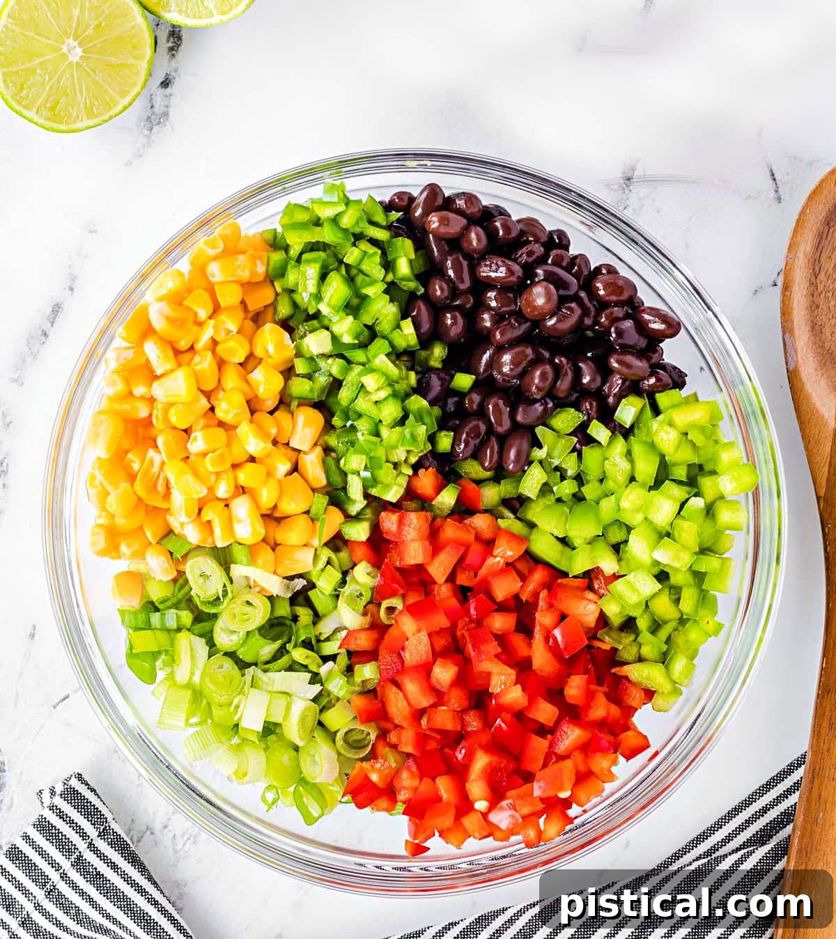 All the fresh ingredients for black bean and corn salsa are prepped and neatly arranged in clear glass bowls, ready to be combined. Diced red bell pepper, green bell pepper, jalapeño, sliced green onions, drained black beans, corn, and cilantro are visible, creating a colorful and inviting display.