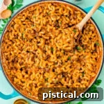skillet of homemade hamburger helper garnished with chopped fresh parsley.