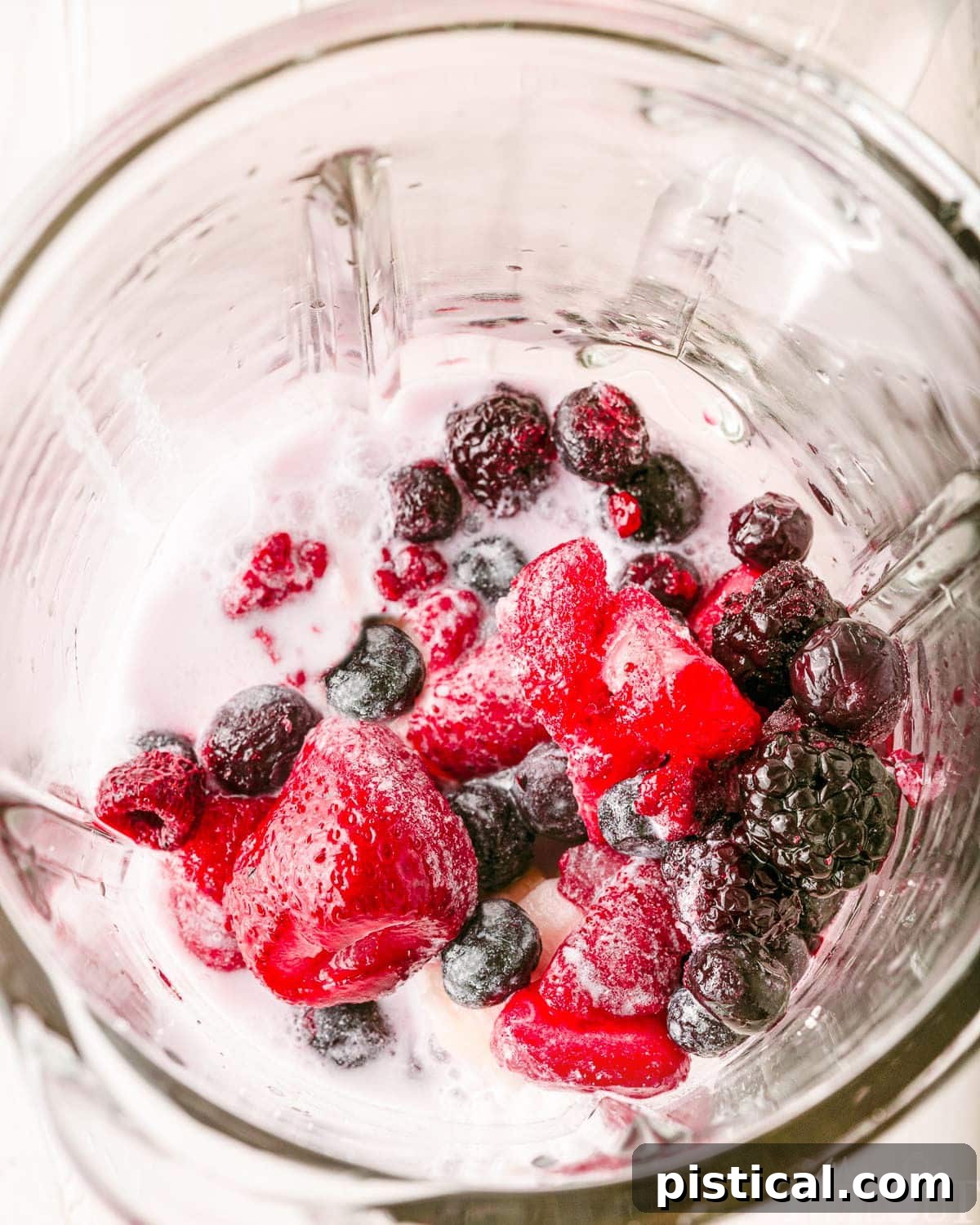 berry smoothie ingredient in a blender ready to be blended.