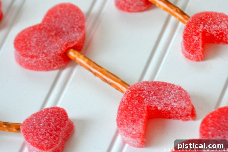 Finished Cupid's Arrow with gumdrop tail and head connected by a pretzel stick, showcasing a sweet Valentine's Day treat