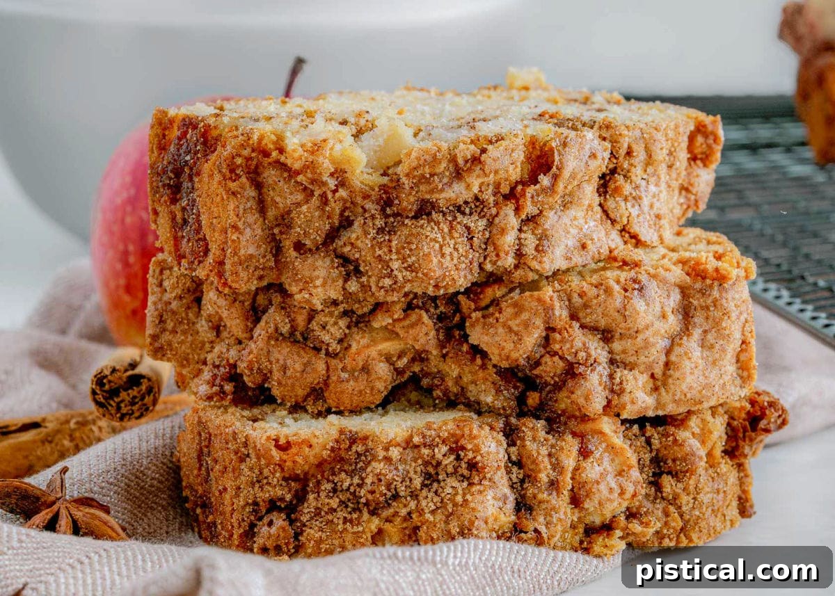 Close-up view of a streusel topping on apple bread, with three slices stacked vertically.