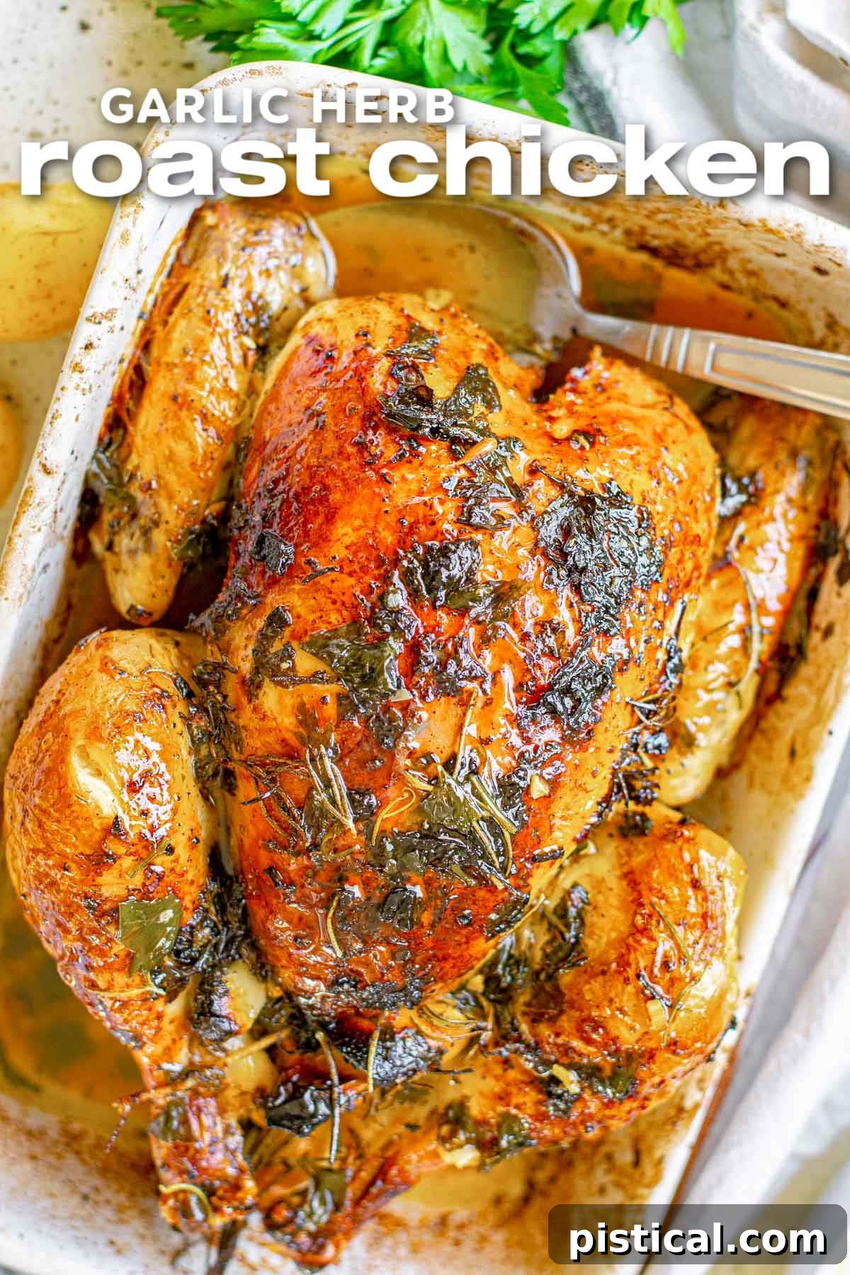 overhead look at roast chicken in white baking dish with crispy skin seasoned with fresh herbs. title at top of image.