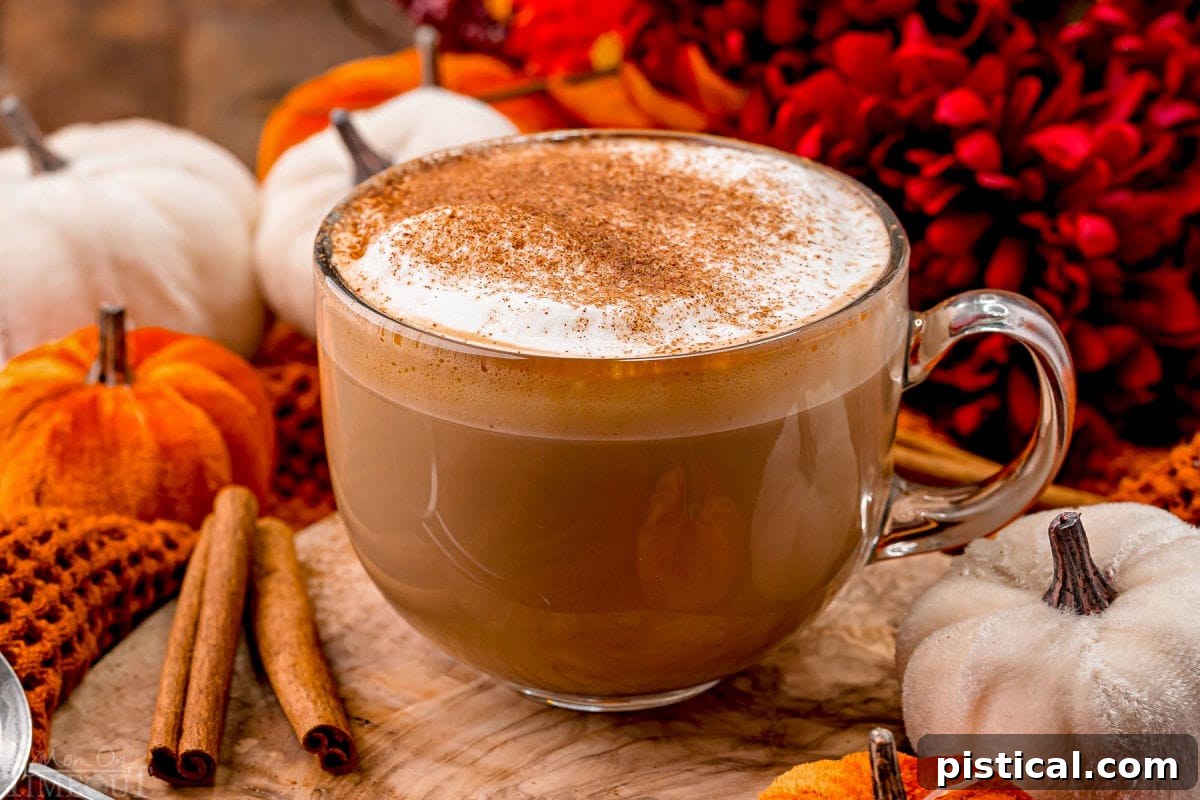 Harvest Spice Latte 6 Angled view of pumpkin spice latte so you can see the layers in the glass mug as well as the pumpkin pie spice topping.