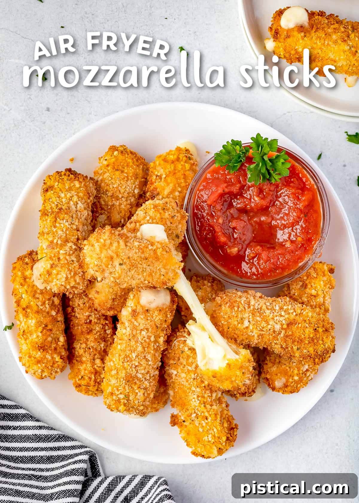 Golden & Gooey Air Fryer Mozzarella Sticks 2 A vibrant pile of golden-brown air fryer mozzarella sticks elegantly arranged on a white plate, served alongside a small bowl of rich marinara sauce, ready to be enjoyed.