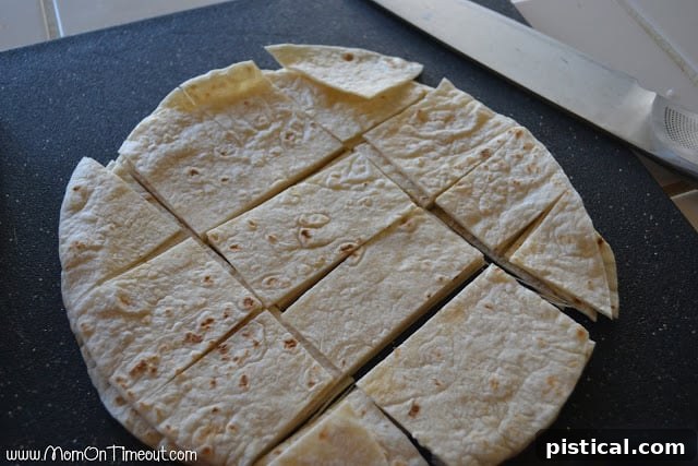 Stacked flour tortillas cut into wedges, ready for frying