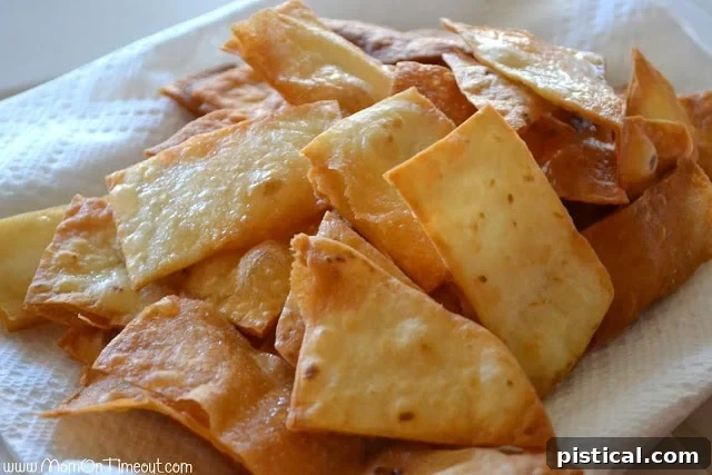 Freshly fried flour tortilla chips draining on paper towels