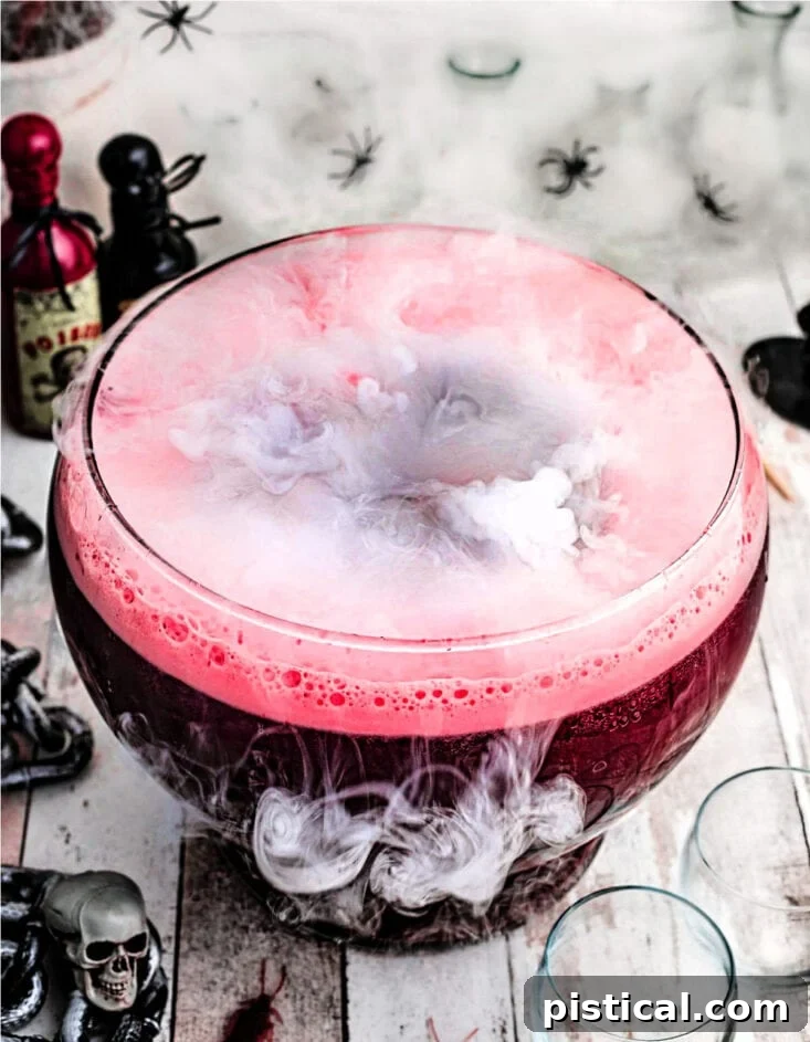 Eerie Elixir 2 Dark red Halloween punch served in a large glass punch bowl with an eerie fog emanating from dry ice, creating a super spooky effect.
