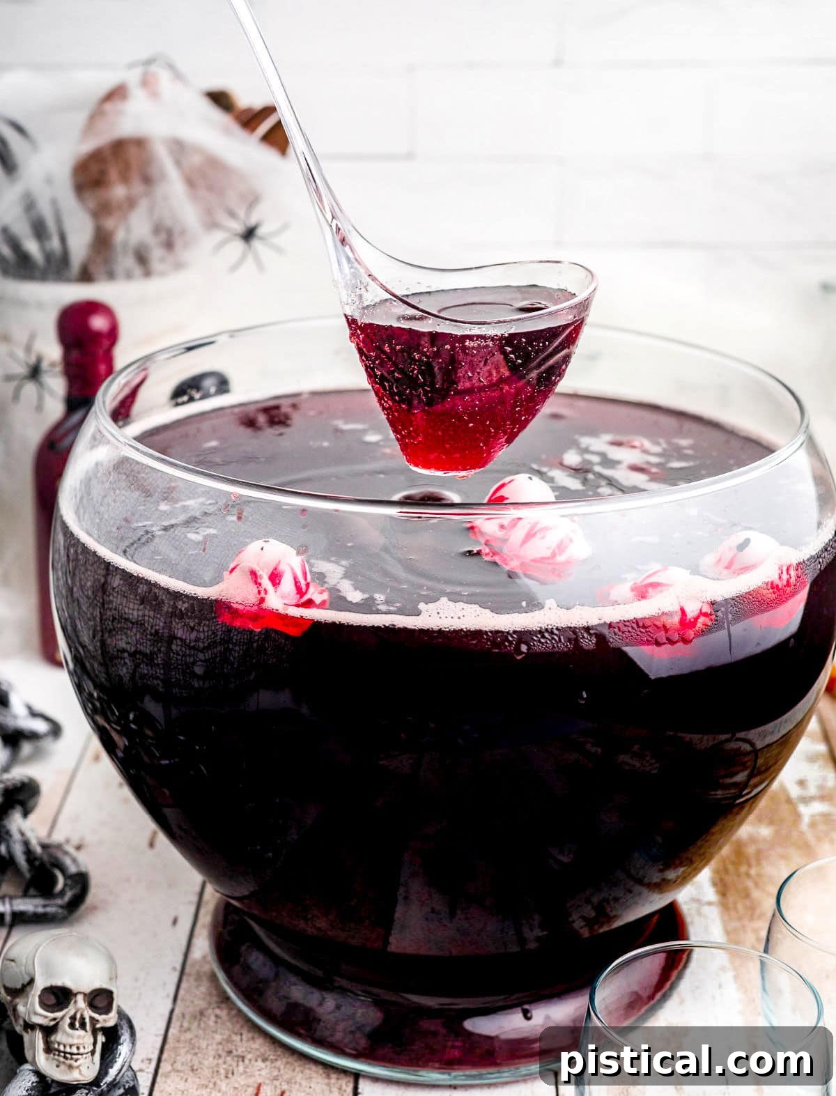 Eerie Elixir 3 A ladle scooping dark red punch from a large, elegant punch bowl, showcasing its rich color and inviting texture.