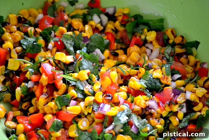 Colorful roasted corn salsa with diced tomatoes, red bell pepper, and cilantro
