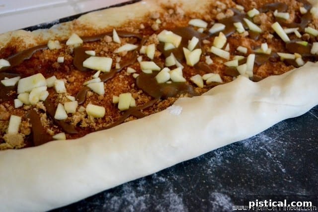Dough log cut into 12 individual sticky buns