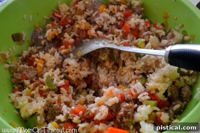 Mixing the stuffed pepper filling ingredients in a bowl