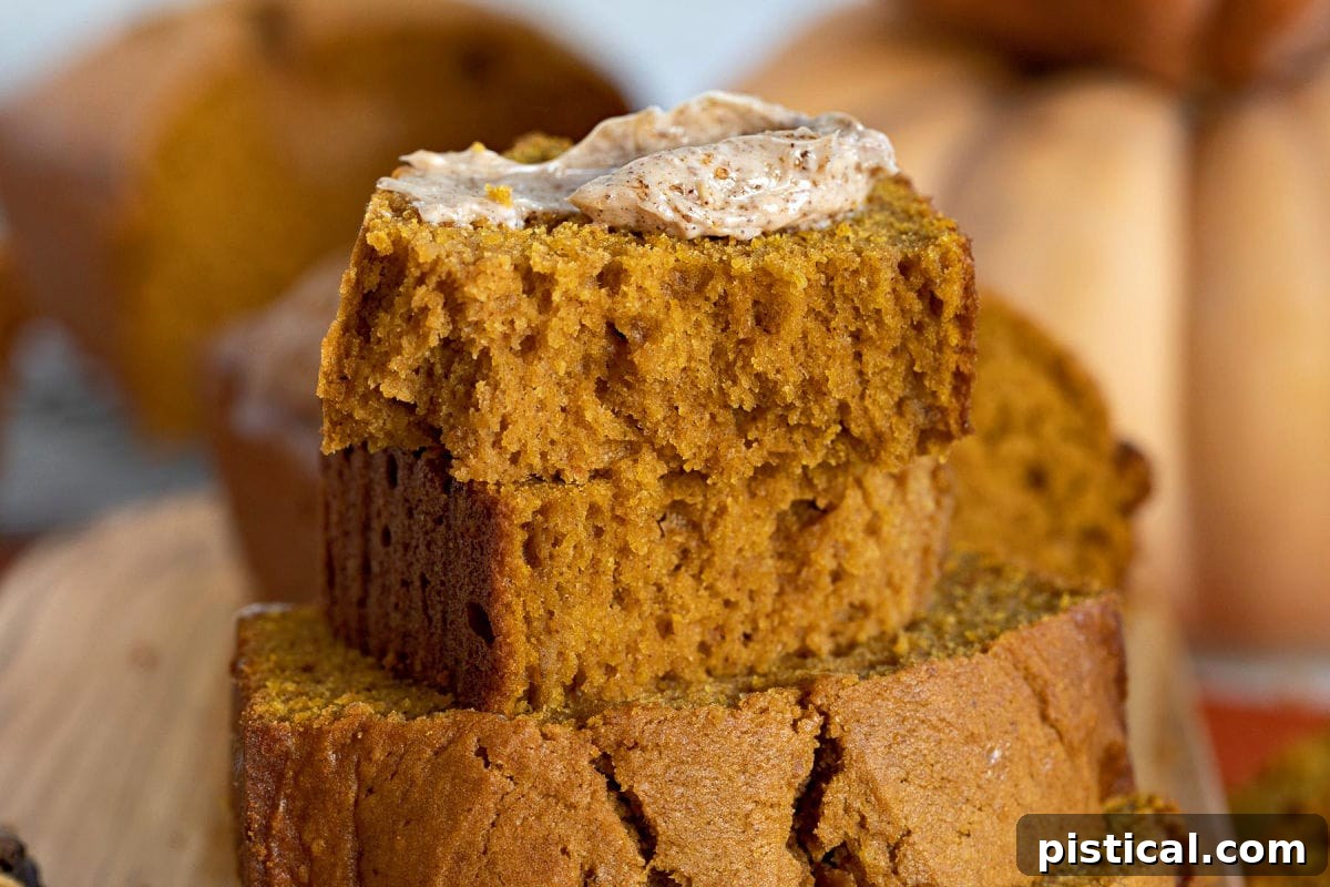 Ultimate Pumpkin Bread 7 A delectable slice of pumpkin bread generously topped with creamy cinnamon brown sugar butter, ready to be enjoyed.