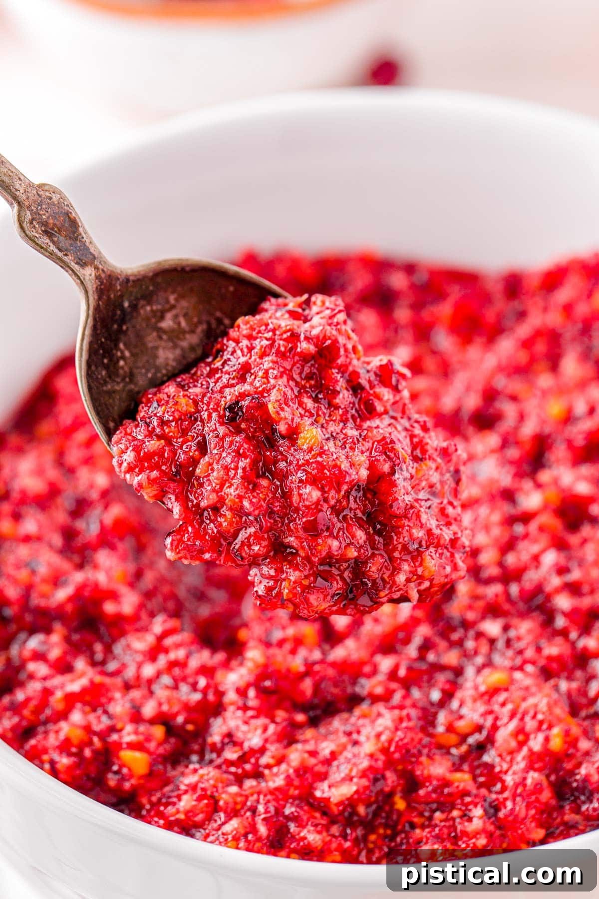 spoonful of relish held above white bowl.