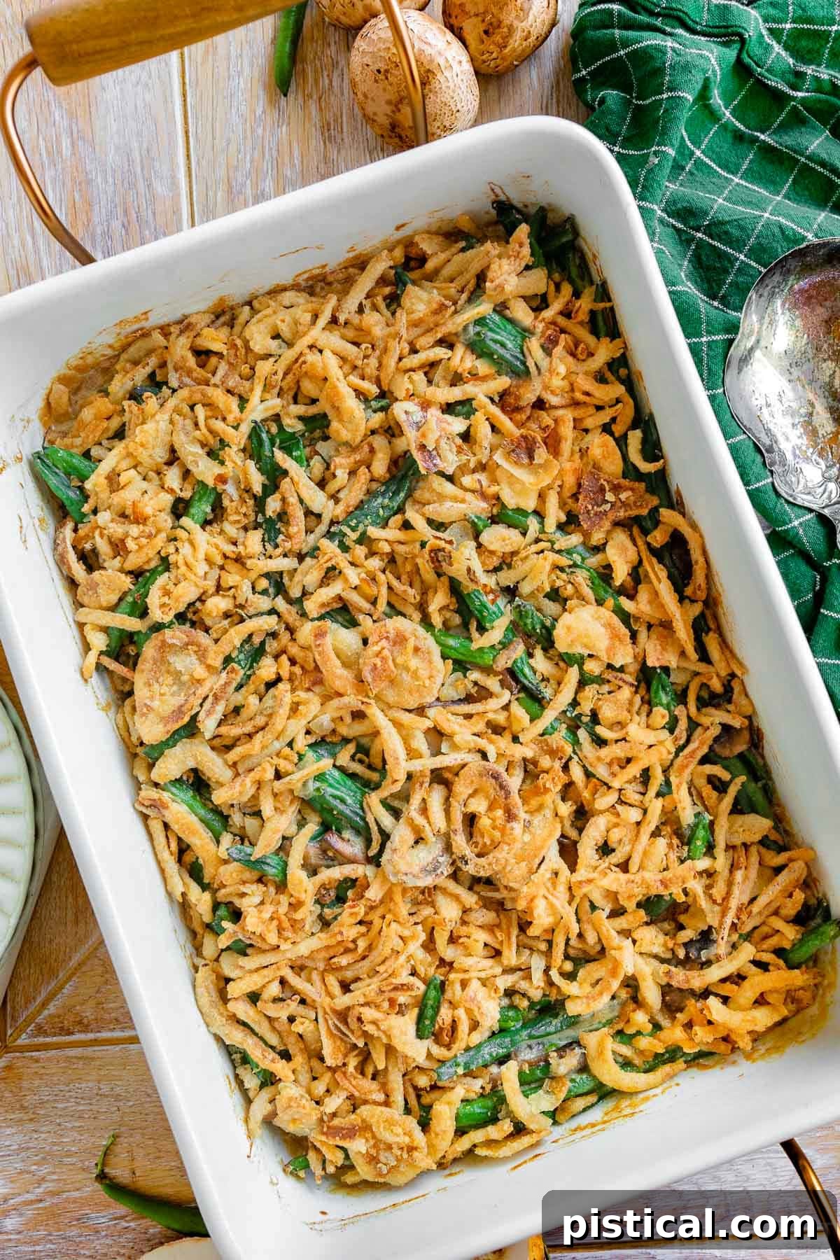 A beautifully presented green bean casserole in a large baking dish, viewed from directly above, inviting diners to enjoy its creamy texture and crispy topping.