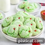 Grinch cake mix cookies with red heart sprinkles