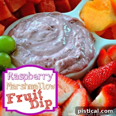 A bowl of creamy Raspberry Marshmallow Fruit Dip with a spoon, ready to be served.