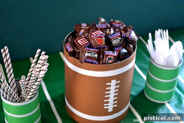 Homemade football-themed snack containers made from cans and construction paper