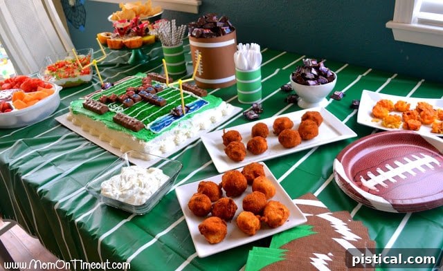 Full game day food spread with football themed decorations