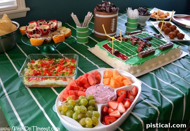 Delicious 7-Layer Dip and fruit platter at a game day party