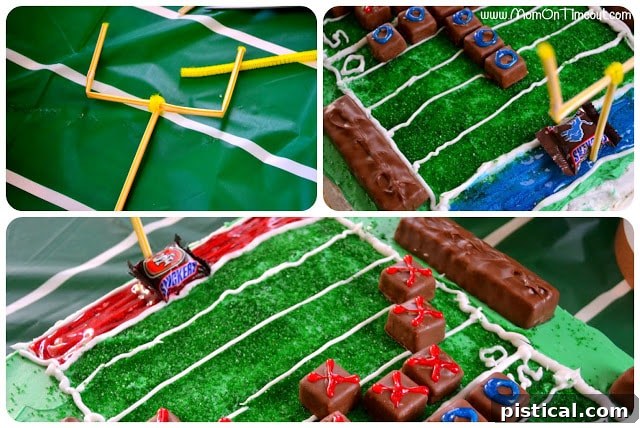 Football field cake with pipe cleaner goal posts and Snickers team candies